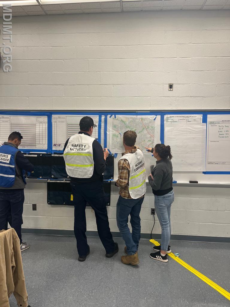 Red Team IC Jonathan Zimmer discusses current ops with DOSC Taylor Munir and SOFR Jason Hardesty. RESL Evan Mason works the &quot;T&quot; Card rack.
