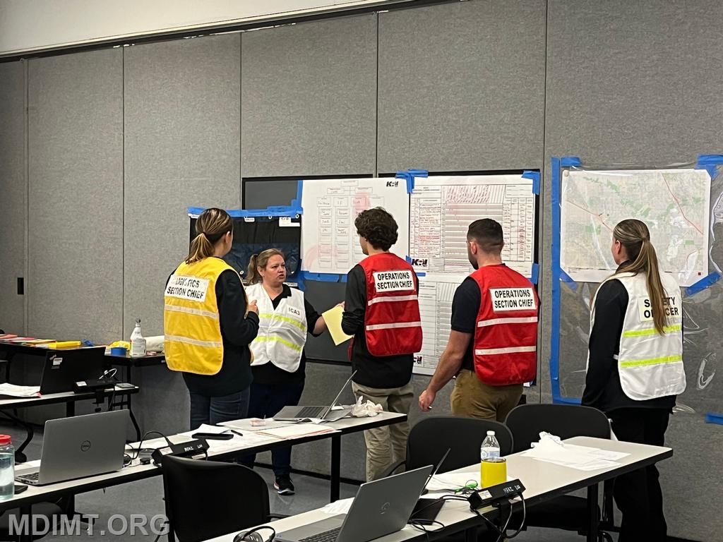 Blue Team I/C Katie Hardin discusses current ops with her staff.