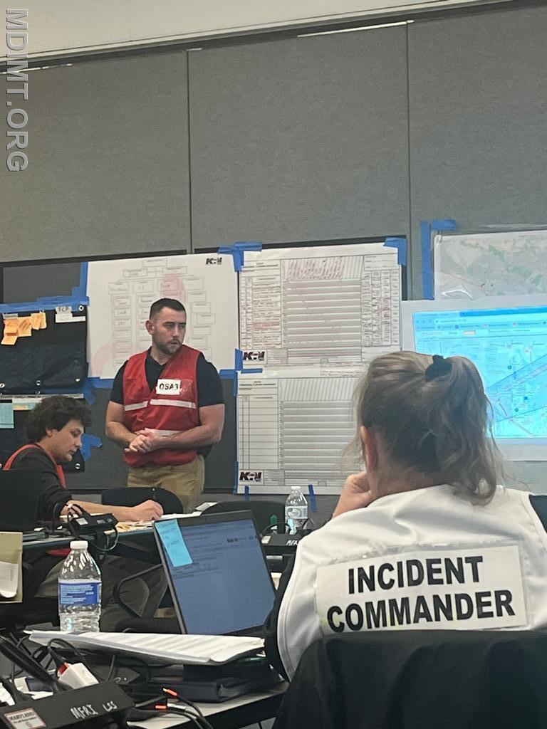 Blue Team OPSC Max Cannon present his plan to Blue IC Katie Hardin.